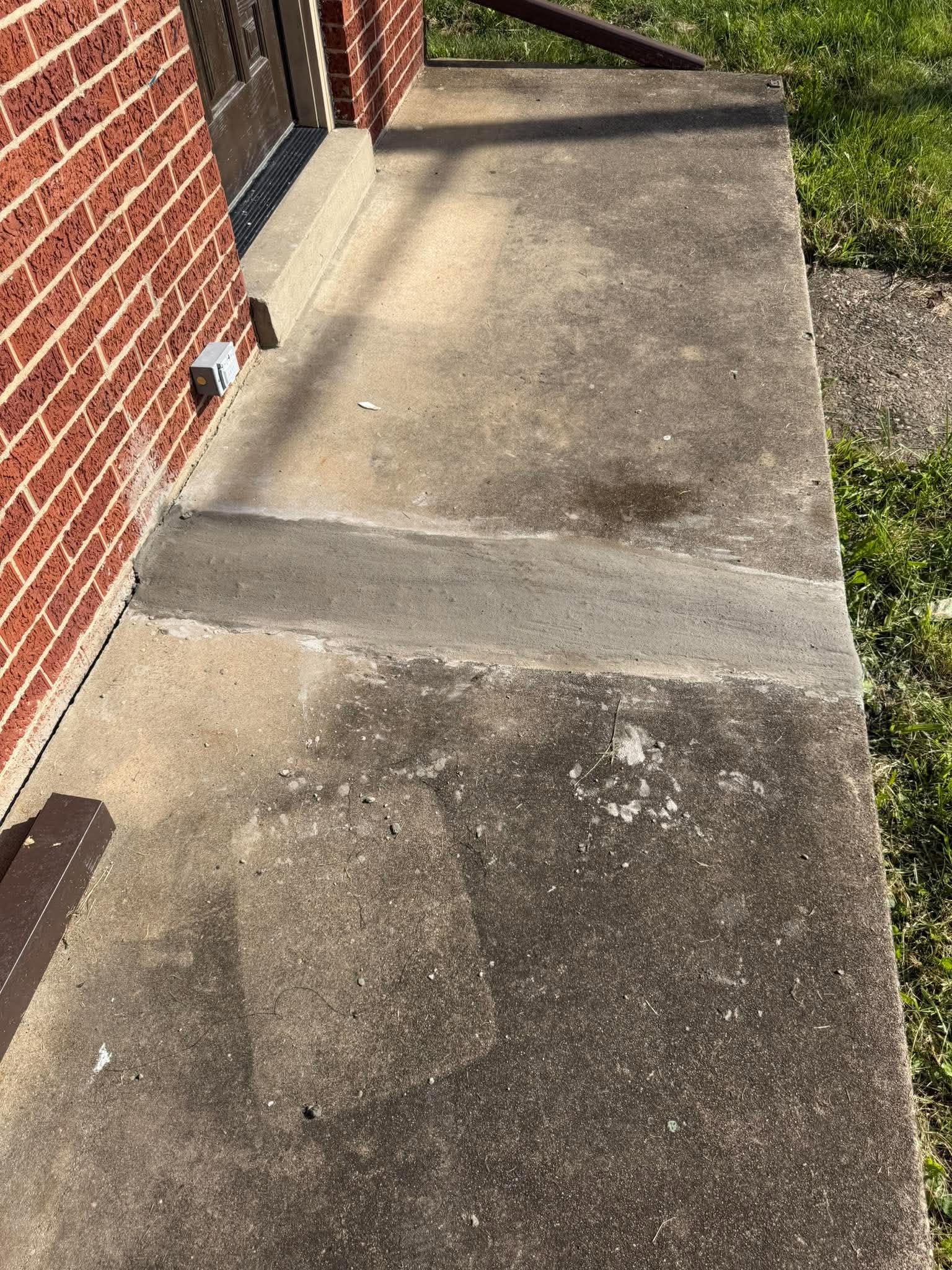 Concrete porch and sidewalk being resurfaced