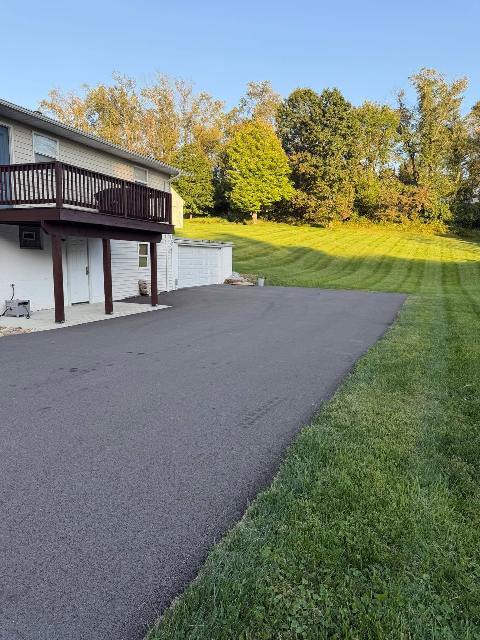 Freshly sealed residential asphalt driveway
