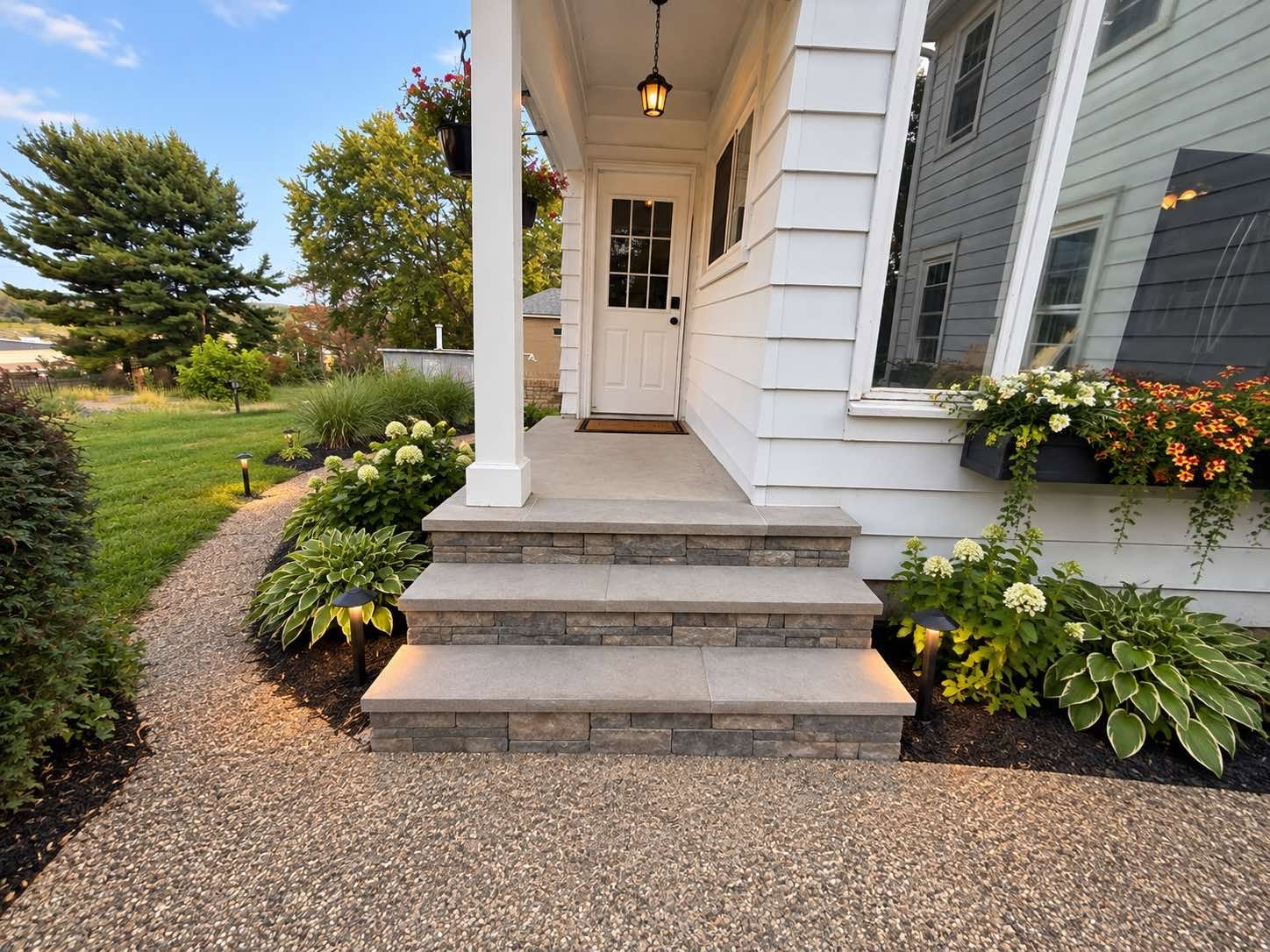 Finished exterior entry steps with landscaped borders