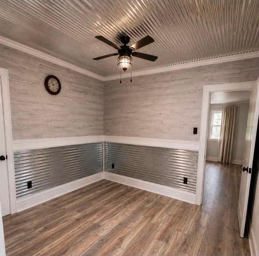 Remodeled empty bedroom with corrugated metal ceiling accent